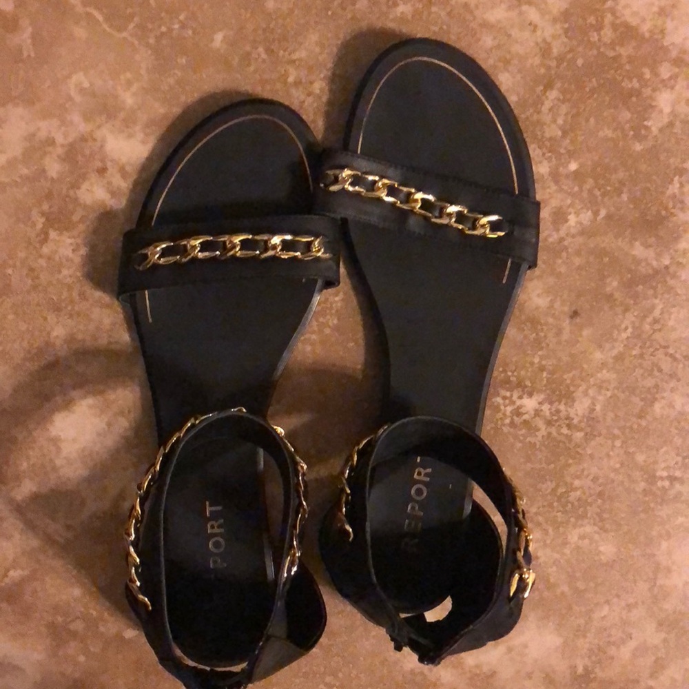Black shoe with gold chain by report